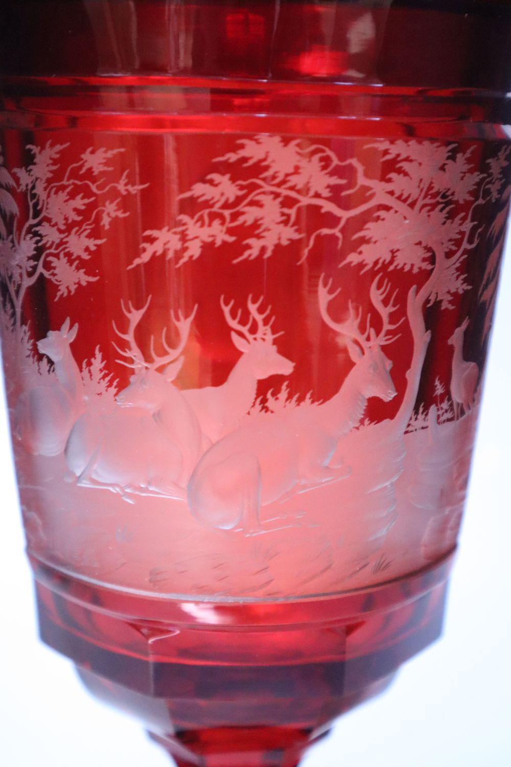 A large Bohemian wheel engraved ruby flash glass vase and cover decorated with deer, late 19th century, 43.5cm